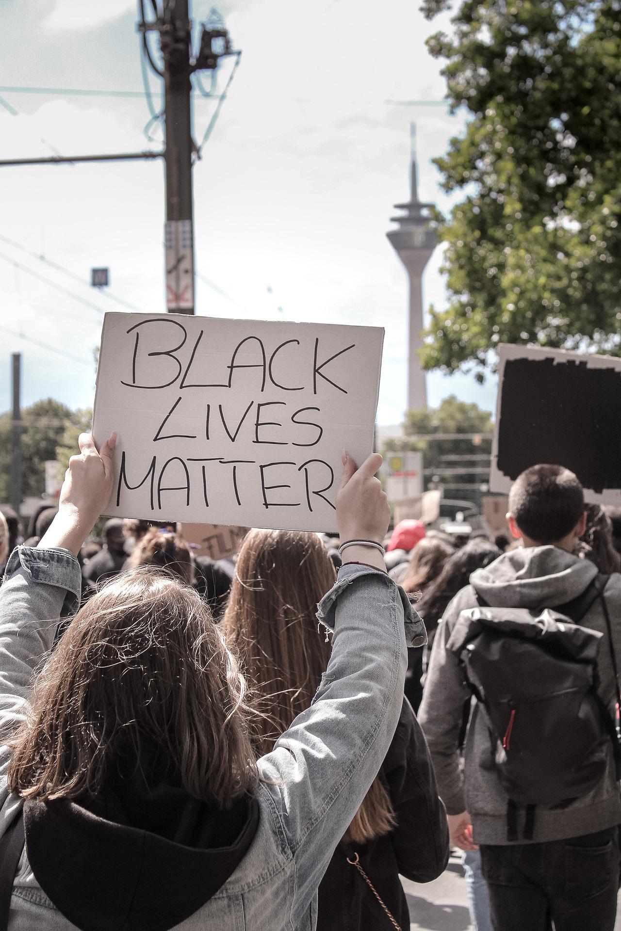 Protester holding up sign that reads Black Lives Matter